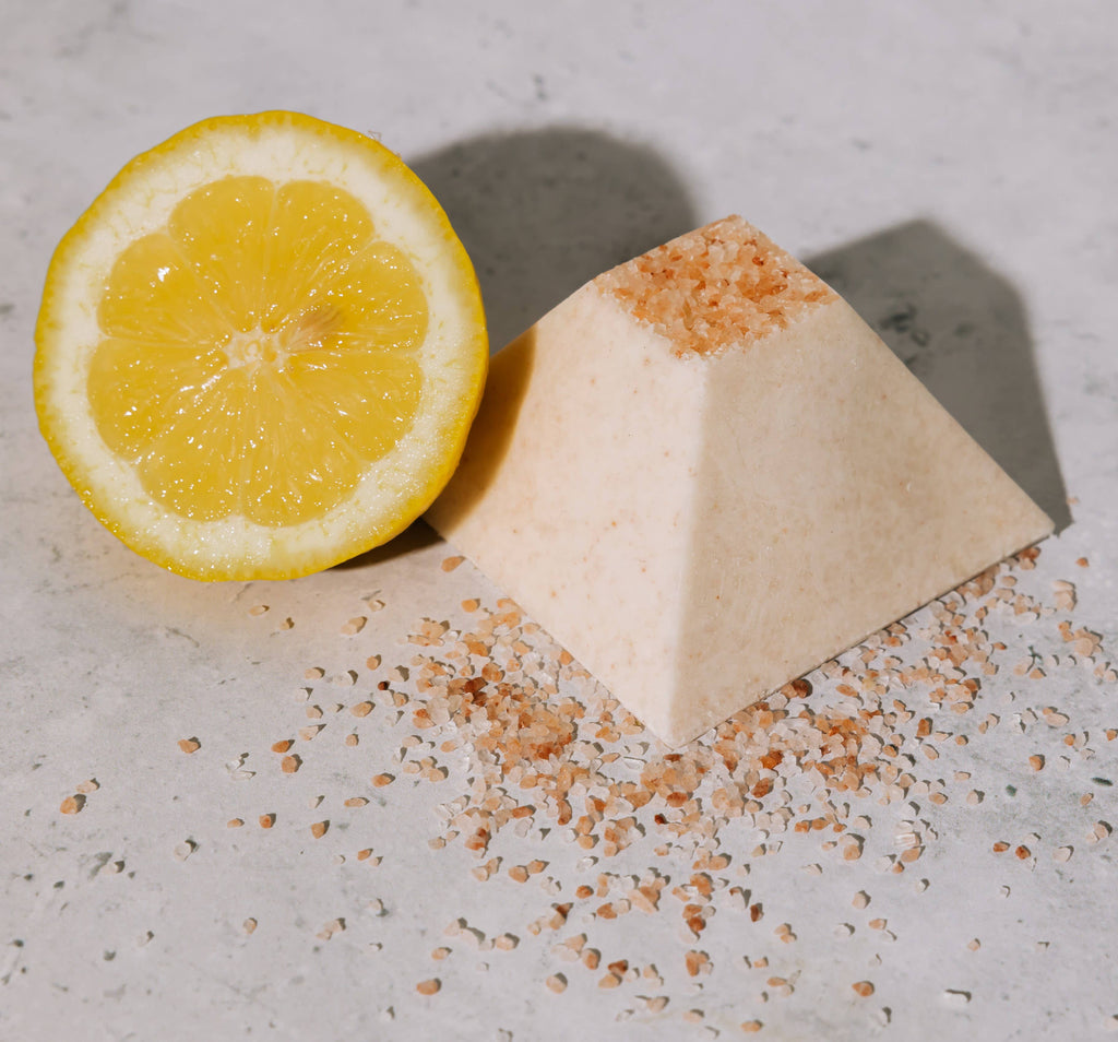 Pyramidal salt soap with lemon on a textured surface